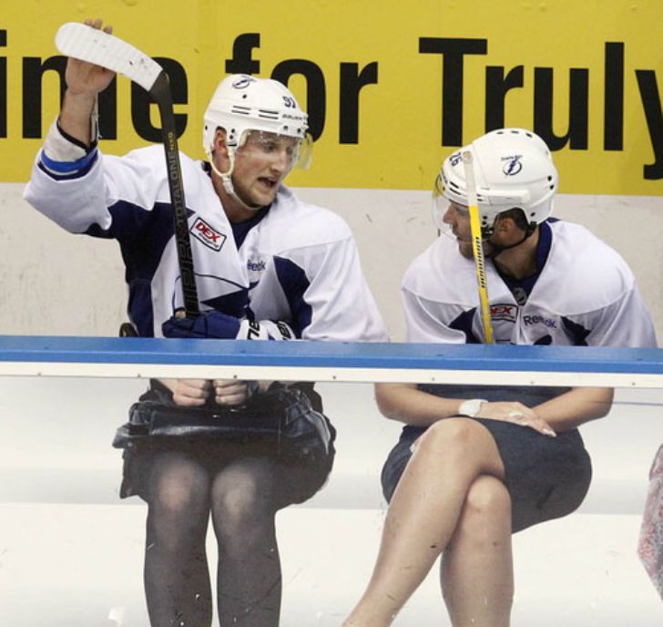 Hockey players appear to have skirted legs due to seat ads