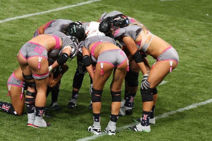 Players in a team huddle on the field