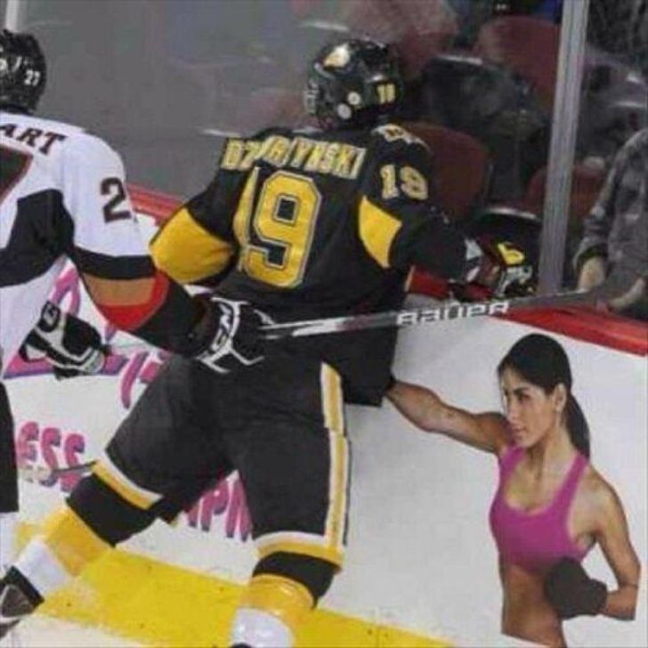 Hockey check lined up with ad board punch