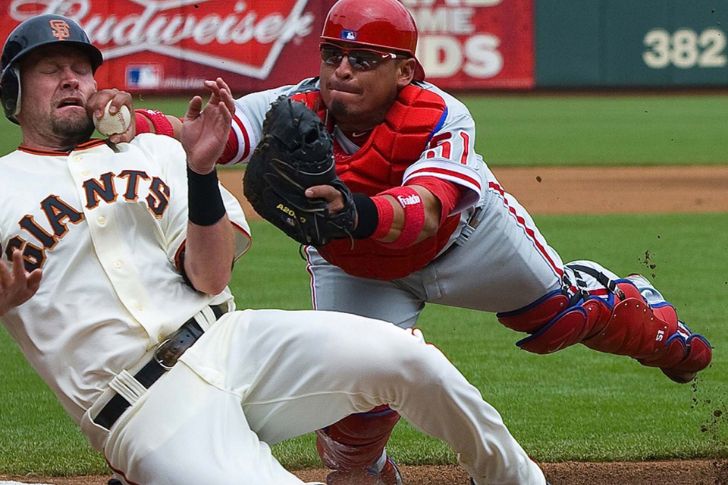 Base runner colliding at home plate