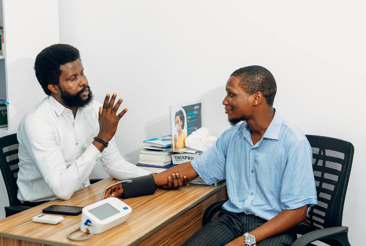 Doctor checks patient blood pressure