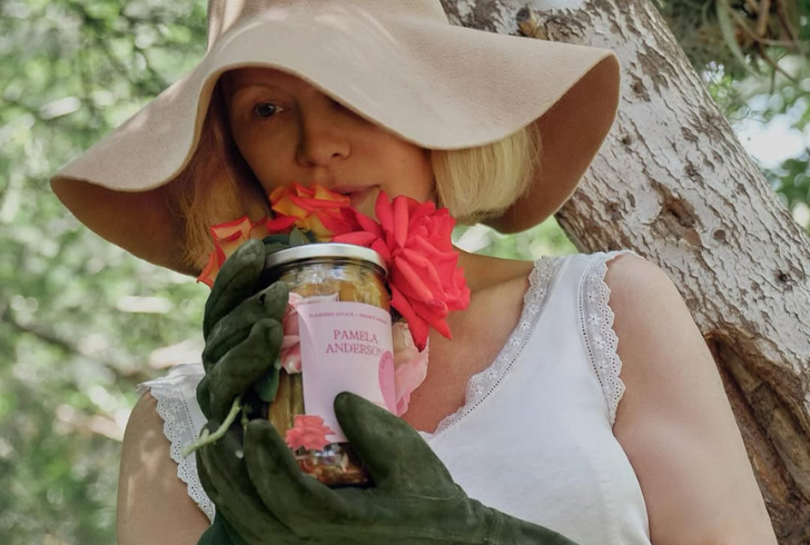 Pamela Anderson holding pickle jar